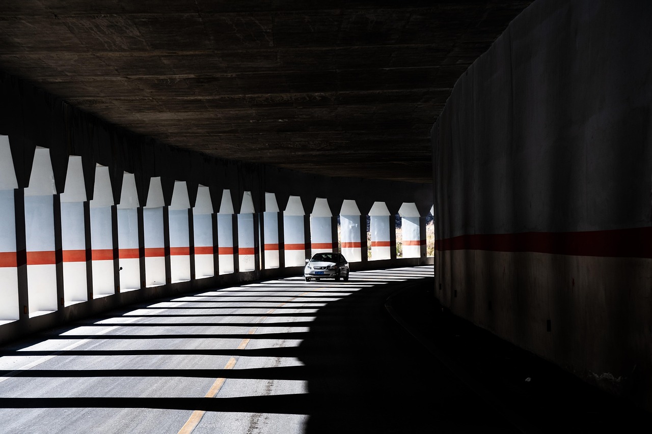 Car driving through sunlit tunnel - representing transformation and growth for paving contractors